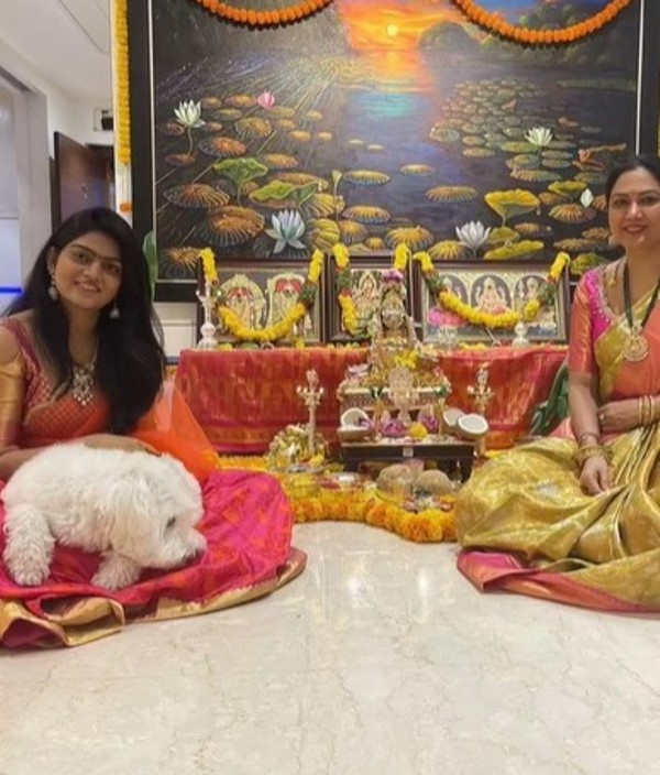 Hema (right) praying at the temple at her home