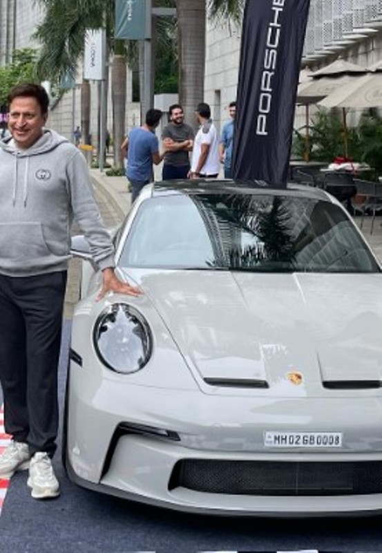Dinesh Thakkar posing withe his Porsche GT 3